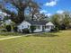 Charming single-story home with a white exterior, black trim, well-manicured lawn, and mature landscaping at 463 Flint Trl, Jonesboro, GA 30236