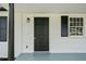 Close-up of the front door featuring black shutters, a classic door, and stylish exterior lighting at 463 Flint Trl, Jonesboro, GA 30236