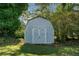 Photo of the property's outbuilding with double doors nestled amongst trees and lawn at 463 Flint Trl, Jonesboro, GA 30236