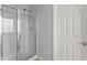 Shower stall with glass door and gray walls at 6615 Grove Meadows Ln, Cumming, GA 30028