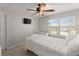 Bedroom with carpet flooring, ceiling fan, and large window at 6615 Grove Meadows Ln, Cumming, GA 30028