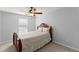 Bedroom with a queen bed, carpet flooring, and a window at 6615 Grove Meadows Ln, Cumming, GA 30028