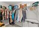 Walk-in closet with clothes and storage at 6615 Grove Meadows Ln, Cumming, GA 30028
