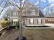 Charming two-story home with symmetrical windows, manicured lawn, and welcoming entrance at 6615 Grove Meadows Ln, Cumming, GA 30028