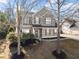 Charming two-story home with a well-maintained lawn and landscaping at 6615 Grove Meadows Ln, Cumming, GA 30028