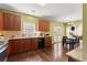 Kitchen boasts granite countertops, stainless steel appliances, and a view to a dining area at 6615 Grove Meadows Ln, Cumming, GA 30028