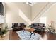 Spacious living room with hardwood floors, fireplace, and comfortable leather seating at 6615 Grove Meadows Ln, Cumming, GA 30028