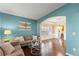Open-concept living area featuring hardwood floors, neutral decor, and ample natural light at 6615 Grove Meadows Ln, Cumming, GA 30028