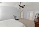 Comfortable main bedroom with a ceiling fan, access to an en-suite, and closet at 6615 Grove Meadows Ln, Cumming, GA 30028