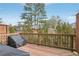 Back deck with railings, grill, and treed backyard view at 1566 Ridgebrook Downs, Mableton, GA 30126