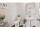 Charming half bathroom featuring a pedestal sink, decorative art, and sleek fixtures at 1566 Ridgebrook Downs, Mableton, GA 30126