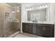 Modern bathroom with a glass-enclosed shower, dual vanities, and contemporary lighting at 1566 Ridgebrook Downs, Mableton, GA 30126