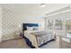 Elegant bedroom with patterned wallpaper, plush blue headboard, and abundant natural light at 1566 Ridgebrook Downs, Mableton, GA 30126