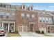 Beautiful brick townhome with an attached garage, manicured lawn, and welcoming entryway at 1566 Ridgebrook Downs, Mableton, GA 30126