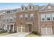 Beautiful brick townhome featuring a one-car garage,dormer windows, and cozy entrance at 1566 Ridgebrook Downs, Mableton, GA 30126