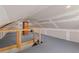Spacious attic featuring newly installed drywall, gray flooring, and exposed brick chimney at 1600 Temple Ave, Atlanta, GA 30337