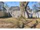 Large backyard featuring a lush green lawn and mature trees providing ample shade at 1600 Temple Ave, Atlanta, GA 30337