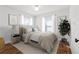 Cozy bedroom with plush bedding, neutral decor, and ample natural light at 1600 Temple Ave, Atlanta, GA 30337