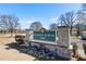 Community park entrance with stone signage surrounded by colorful flowers and greenery at 1600 Temple Ave, Atlanta, GA 30337