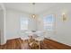 Bright dining room with a marble table, stylish chairs, hardwood floors and pendant lighting at 1600 Temple Ave, Atlanta, GA 30337