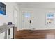 Bright entryway featuring hardwood floors, white trim, and a modern door with glass panels at 1600 Temple Ave, Atlanta, GA 30337