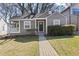 Charming home with neutral colored siding, a neatly landscaped yard, and inviting front porch at 1600 Temple Ave, Atlanta, GA 30337