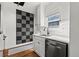 Well-lit kitchen with stainless steel appliances, white cabinets, and a modern sink at 1600 Temple Ave, Atlanta, GA 30337