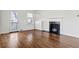 Bright living room with hardwood floors, a fireplace, and access to an outdoor space at 1600 Temple Ave, Atlanta, GA 30337