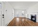 A well-lit living room featuring a black tiled fireplace, hardwood floors, and neutral decor at 1600 Temple Ave, Atlanta, GA 30337