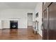 Living room showcasing a fireplace with black tile surround and refinished hardwood floors at 1600 Temple Ave, Atlanta, GA 30337