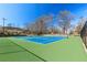 Bright and spacious tennis courts surrounded by mature trees under a clear blue sky at 1600 Temple Ave, Atlanta, GA 30337