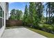 Backyard area featuring a concrete patio, privacy fence, and lush landscaping along a creek at 1891 Audubon Park Ln, Decatur, GA 30033