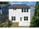 A simple two-story home displays its backyard with a concrete patio and an expansive lawn at 1891 Audubon Park Ln, Decatur, GA 30033