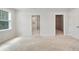 Bright bedroom features neutral walls, carpet, and two doorways to ensuite bathroom and walk-in closet at 1891 Audubon Park Ln, Decatur, GA 30033
