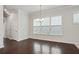 Bright dining area with hardwood floors, chandelier, and large windows providing natural light at 1891 Audubon Park Ln, Decatur, GA 30033