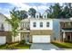 Charming two-story home with brick facade, white accents, a two-car garage, and well-manicured lawn at 1891 Audubon Park Ln, Decatur, GA 30033