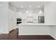 Modern kitchen featuring white cabinetry, stainless steel appliances, quartz countertops, and a center island at 1891 Audubon Park Ln, Decatur, GA 30033