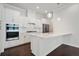 Modern kitchen showcasing white cabinets, stainless steel appliances, and a quartz countertop island at 1891 Audubon Park Ln, Decatur, GA 30033