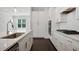 Close-up of a modern kitchen with white cabinets, quartz countertops, and stainless steel appliances at 1891 Audubon Park Ln, Decatur, GA 30033