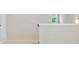 An upper landing showcases neutral carpet, and bright sunlight through a window at 1891 Audubon Park Ln, Decatur, GA 30033