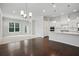 Open-concept living room with hardwood floors, carpeted area, and an adjoining kitchen with modern appliances at 1891 Audubon Park Ln, Decatur, GA 30033