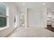 Bright living room features light-colored walls, carpet, and an entrance to the kitchen and backyard access at 1891 Audubon Park Ln, Decatur, GA 30033