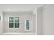 A brightly lit living room with a large window and glass door leads to backyard access at 1891 Audubon Park Ln, Decatur, GA 30033