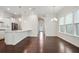 Bright open living space with hardwood floors, recessed lighting, and a view of the modern kitchen at 1891 Audubon Park Ln, Decatur, GA 30033