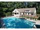 Enjoy this community pool, surrounded by lounge chairs, shade umbrellas, and mature trees at 1891 Audubon Park Ln, Decatur, GA 30033