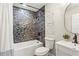 Updated bathroom featuring a tub with a unique tiled wall, and a modern vanity at 253 Mcintosh Avenue Ne, Marietta, GA 30060