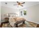 Cozy bedroom with neutral walls, wood floors, ceiling fan, and lots of natural light at 253 Mcintosh Avenue Ne, Marietta, GA 30060