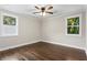 Spacious bedroom with hardwood floors, a ceiling fan, and two windows that provide plenty of light at 253 Mcintosh Avenue Ne, Marietta, GA 30060