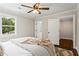 Bright bedroom with a ceiling fan, two windows, and a closet at 253 Mcintosh Avenue Ne, Marietta, GA 30060