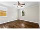Light-filled bedroom featuring hardwood floors and two windows overlooking the backyard at 253 Mcintosh Avenue Ne, Marietta, GA 30060